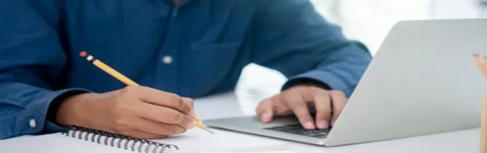 man doing research and using a computer