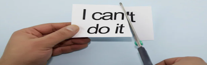 someone cutting the final t off a piece of paper that says I can't do it