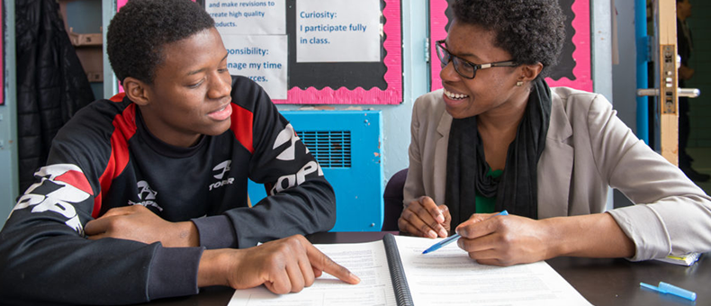 student getting helpfrom teacher