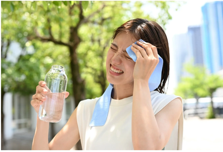 sweating woman drinking water