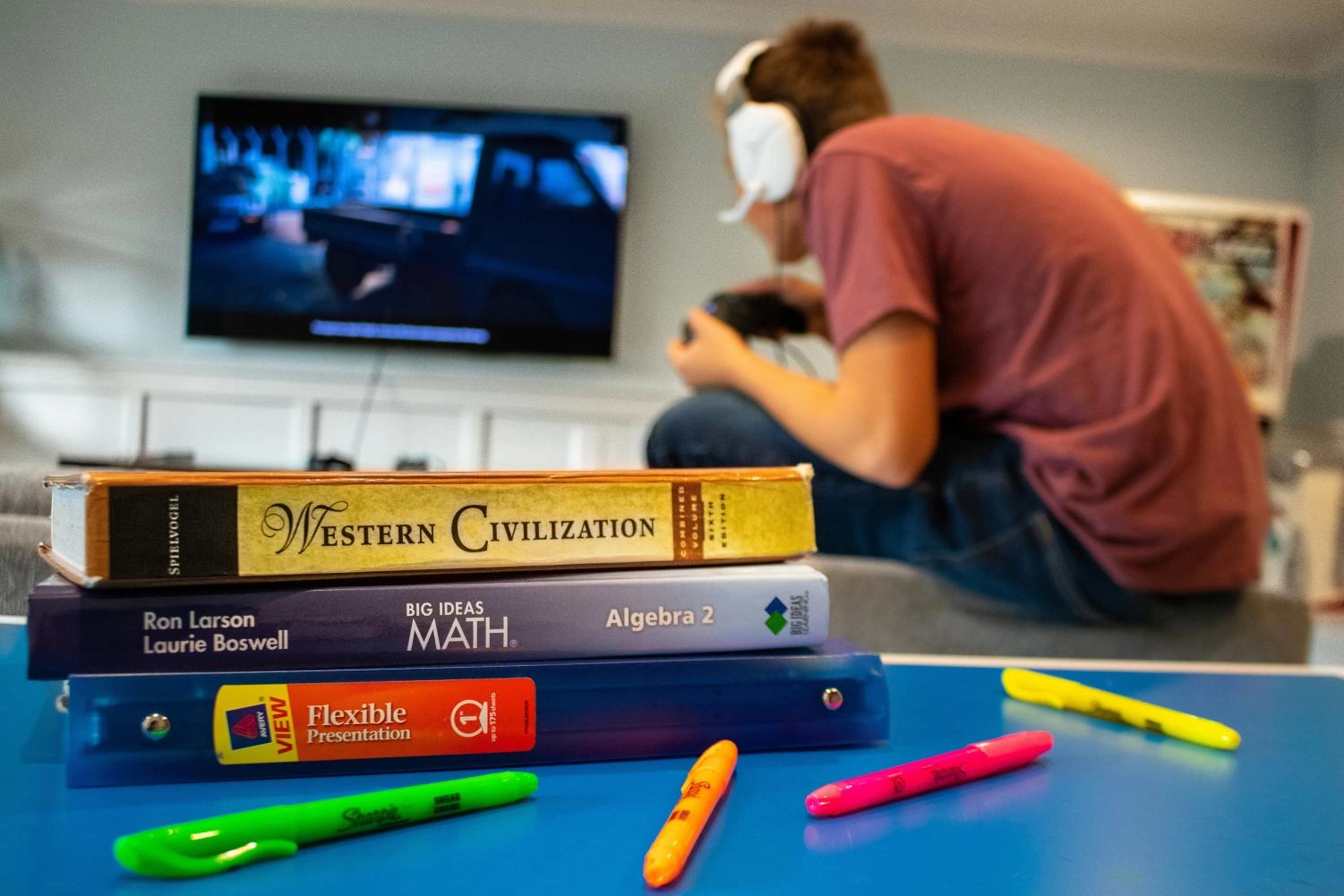 student playing video games instead of doing homework